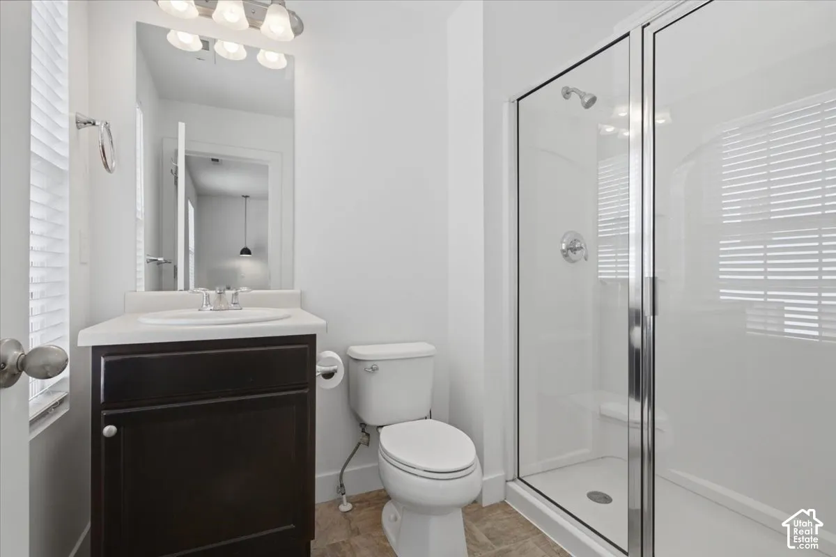 White vanity with an integrated sink, polished chrome faucet, and dark wood-finish cabinetry