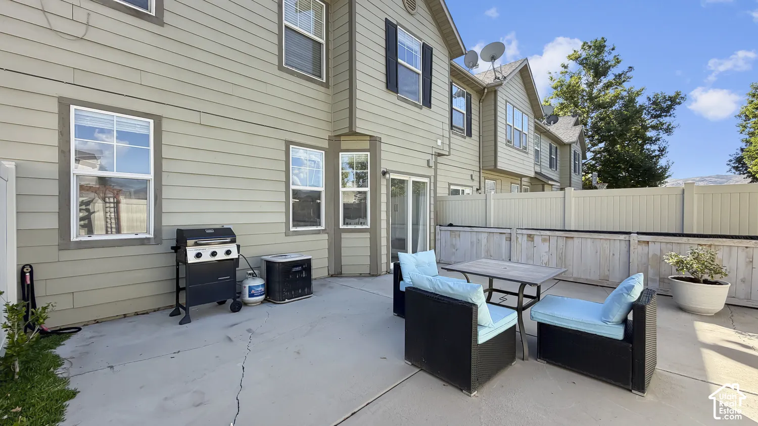 Private patio area featuring a concrete surface and perimeter fencing