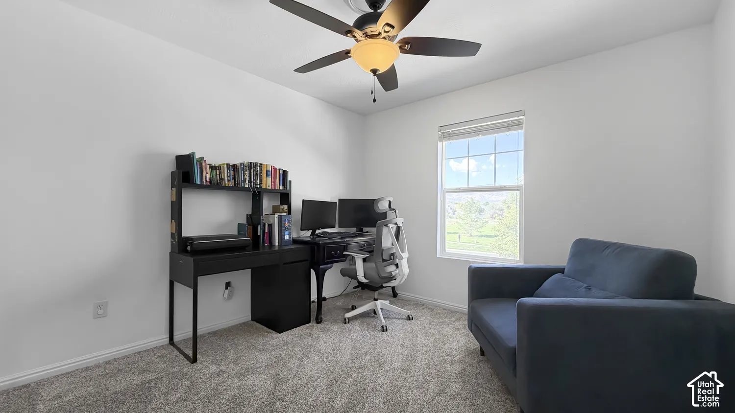 Recessed window with white trim, neutral wall paint, and textured carpet flooring