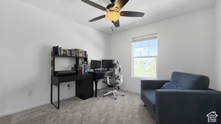 Recessed window with white trim, neutral wall paint, and textured carpet flooring
