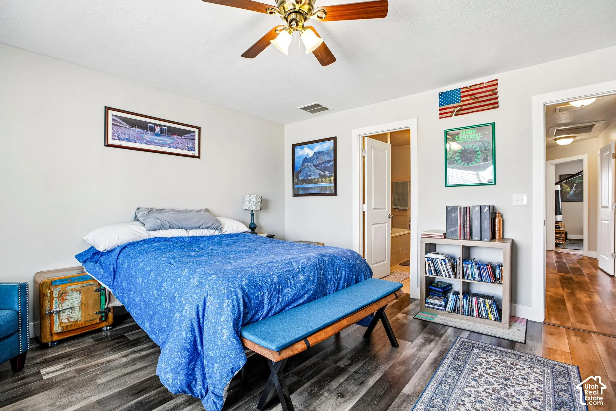 Wood-finish flooring, ceiling fan with integrated lighting, and light-toned wall paint
