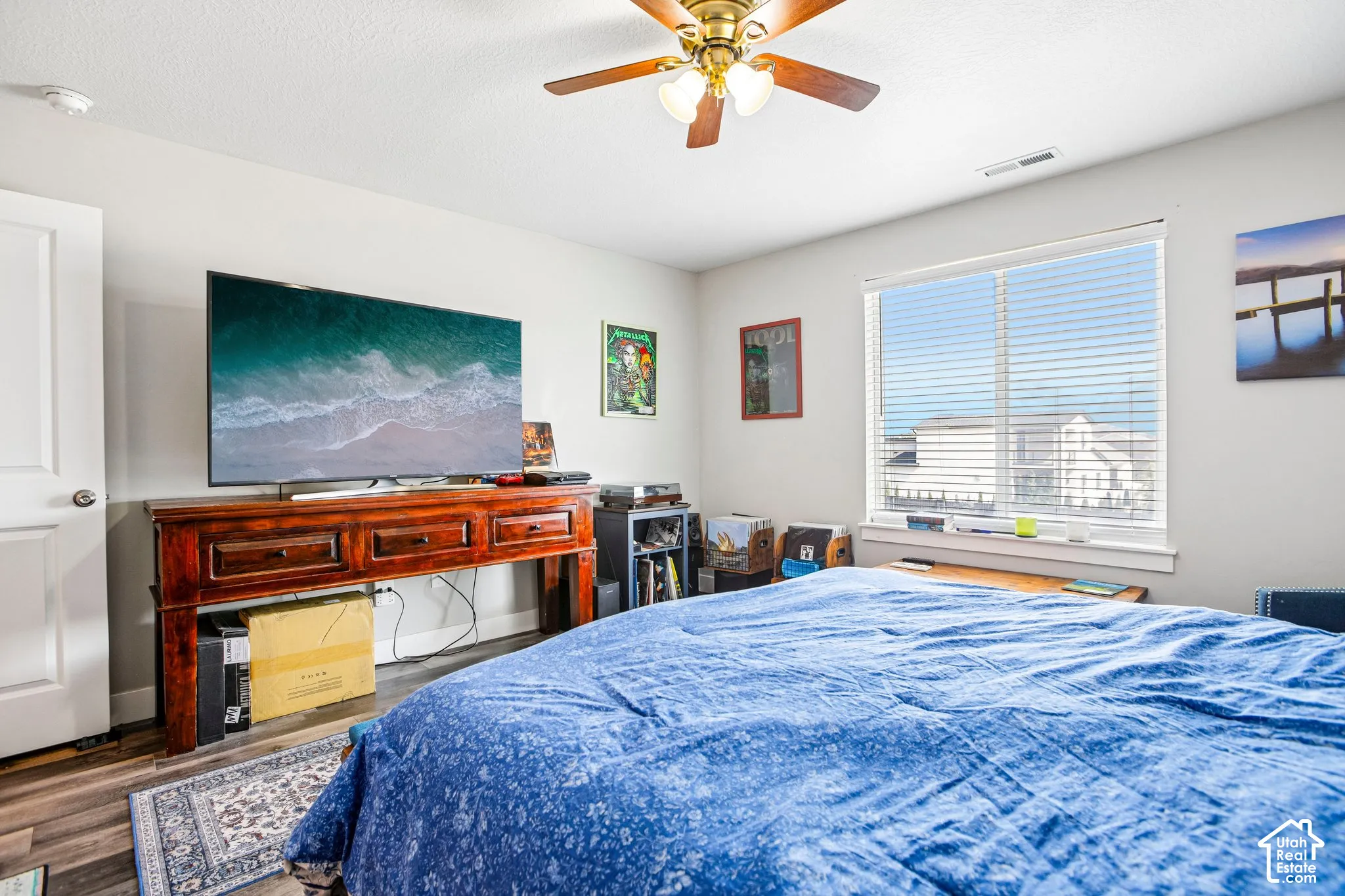 Wood-finish flooring with a ceiling fan light fixture