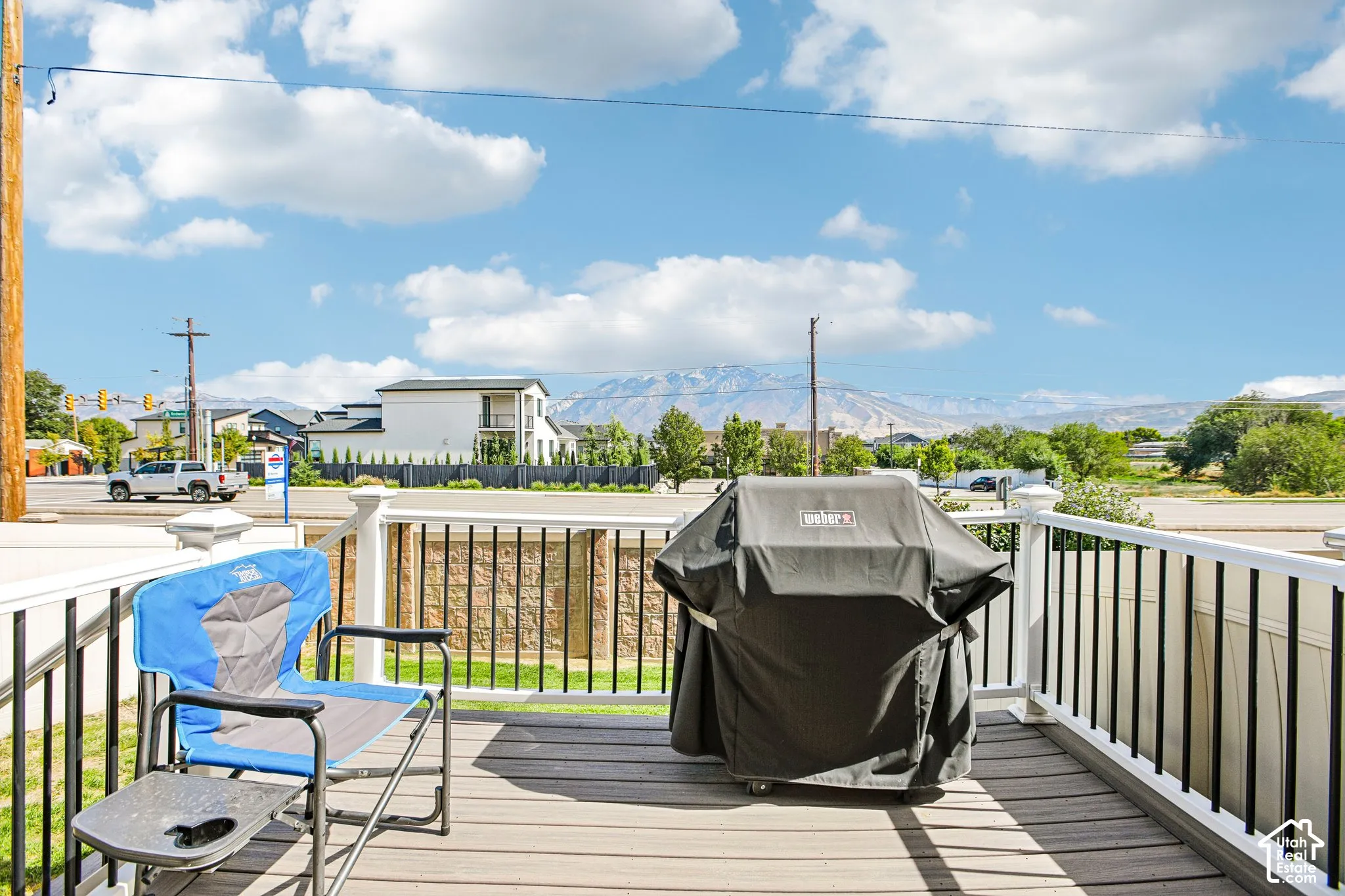 Elevated composite decking with white railing and black balusters