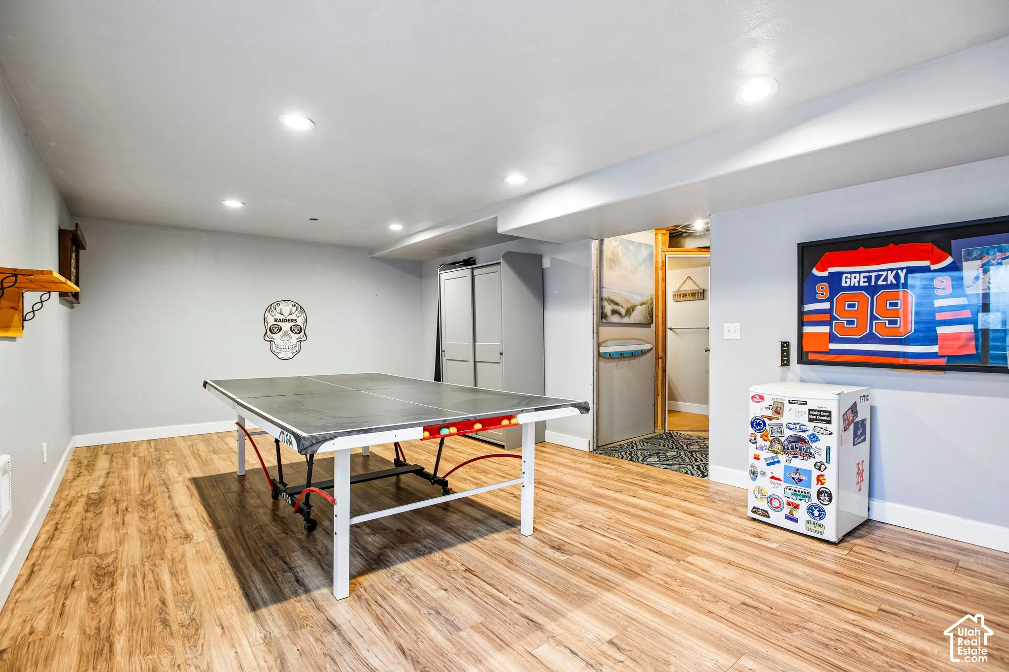 Wood-finish flooring throughout, recessed ceiling lighting, and light gray walls