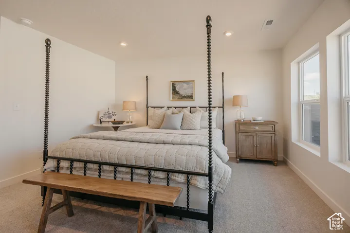 Bright room featuring recessed lighting, light-toned walls, and carpeted flooring