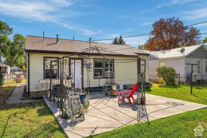 Rear patio with a metal gazebo structure and a concrete surface