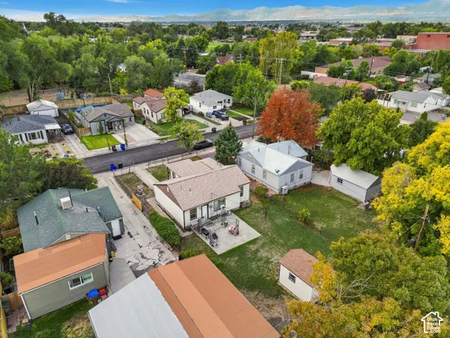 Expansive property featuring a large grassy area, a concrete patio, and a detached shed