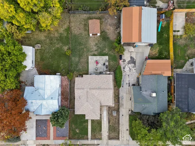Expansive property featuring a main residence with a gabled roof, an accessory dwelling unit, a detached garage, a storage shed, and a concrete patio