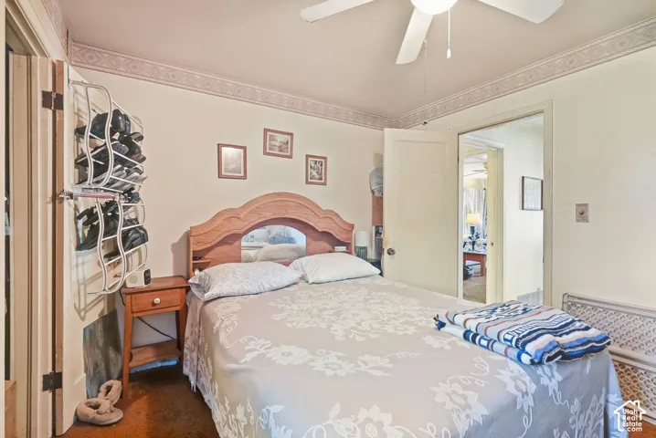 Wood-finish flooring with light-toned walls and a ceiling fan