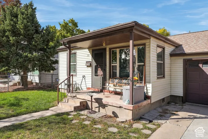 Front exterior with light-colored siding and a covered porch
