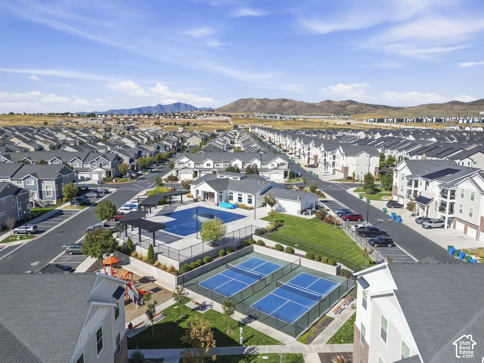 Community featuring a central recreational area with a swimming pool, two tennis courts, and a playground