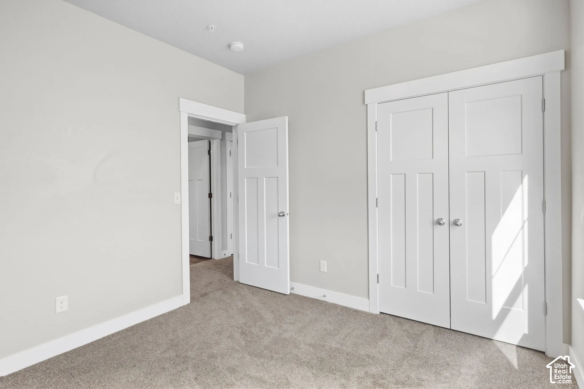 Neutral wall paint with textured carpet flooring