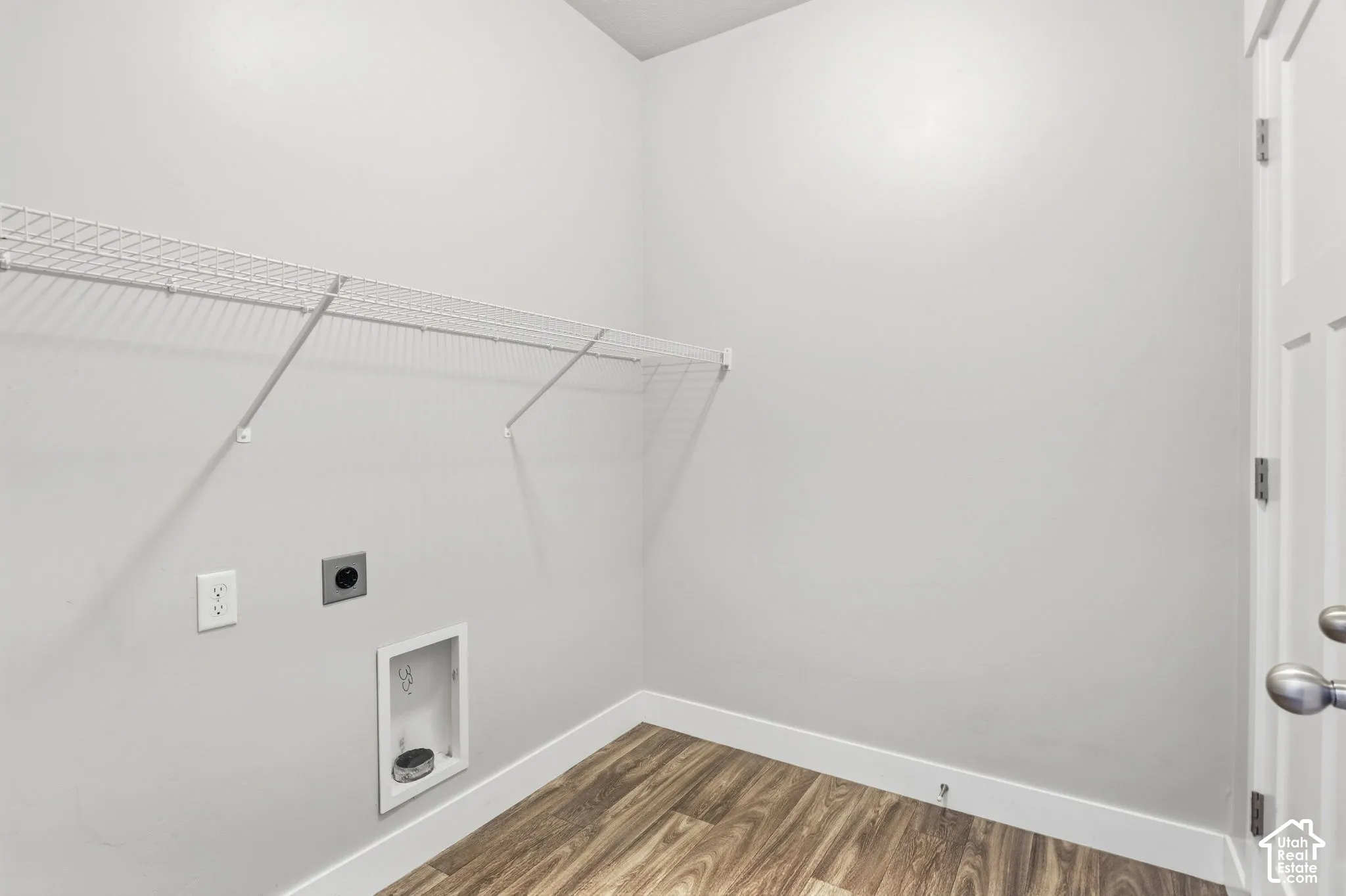 Wire shelving, wood-finish flooring, and a paneled door