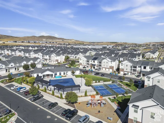 Community amenities featuring a swimming pool, shaded pergolas, tennis courts, and a playground