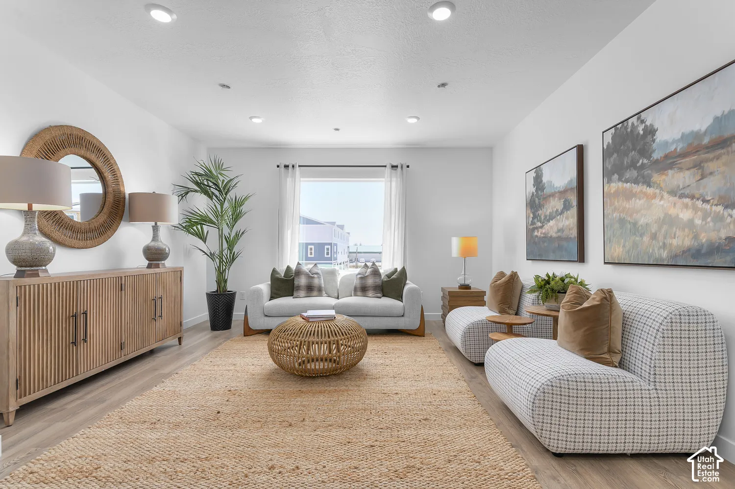 Recessed ceiling lighting illuminates the spacious interior with light wood-finish flooring