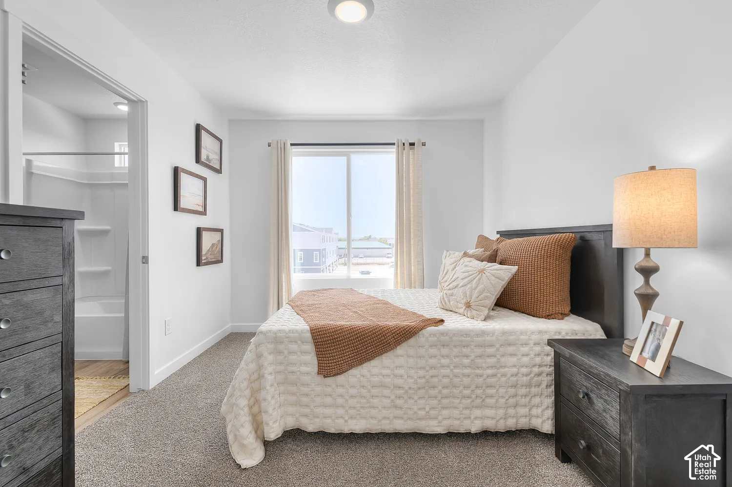 Carpeted flooring, white interior walls, and a sliding glass door