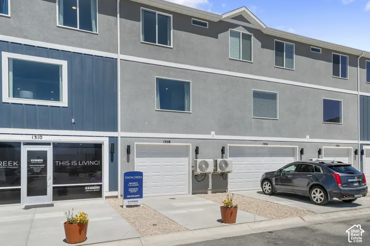 Multi-story townhome with stucco and vertical siding exterior