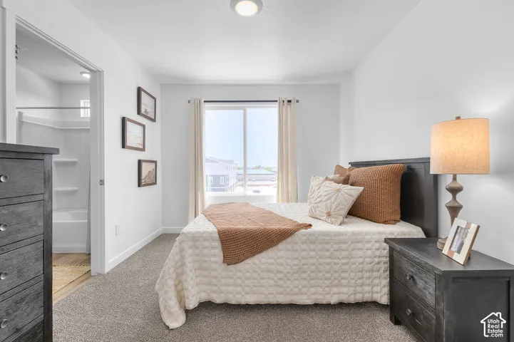 Carpeted flooring, white interior walls, and a sliding glass door