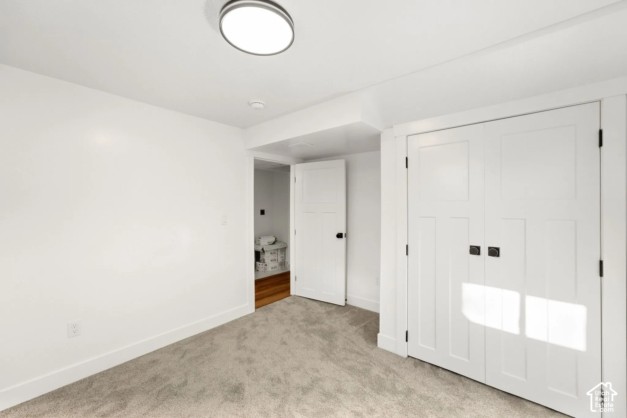 Grey carpeted flooring with white trim