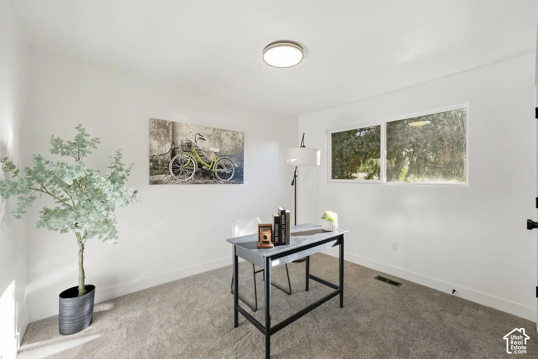 White painted walls, two rectangular windows, and a flush mount ceiling light