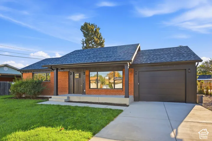 Brick and wood-paneled exterior with a dark asphalt shingle roof