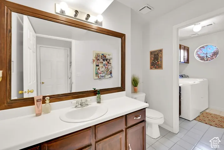 Bathroom vanity with an integrated sink, wood-finish cabinetry, and a framed mirror