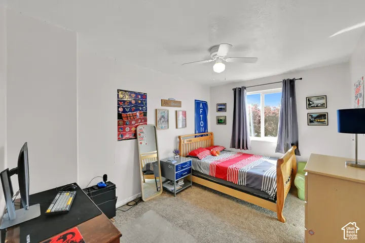 Window with outdoor scenery, recessed lighting, ceiling fan, and carpet flooring