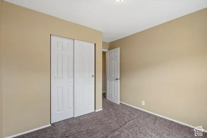 Neutral-toned walls complement the textured carpet flooring