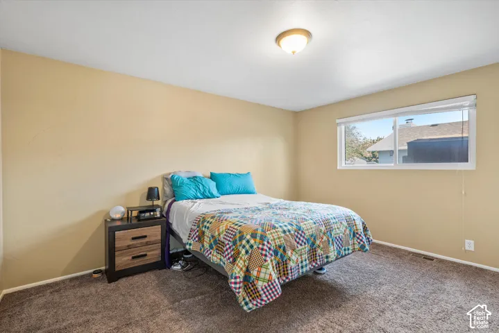 Recessed lighting and a single window with white blinds