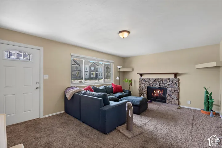Living area with a stone-clad fireplace and wood mantel