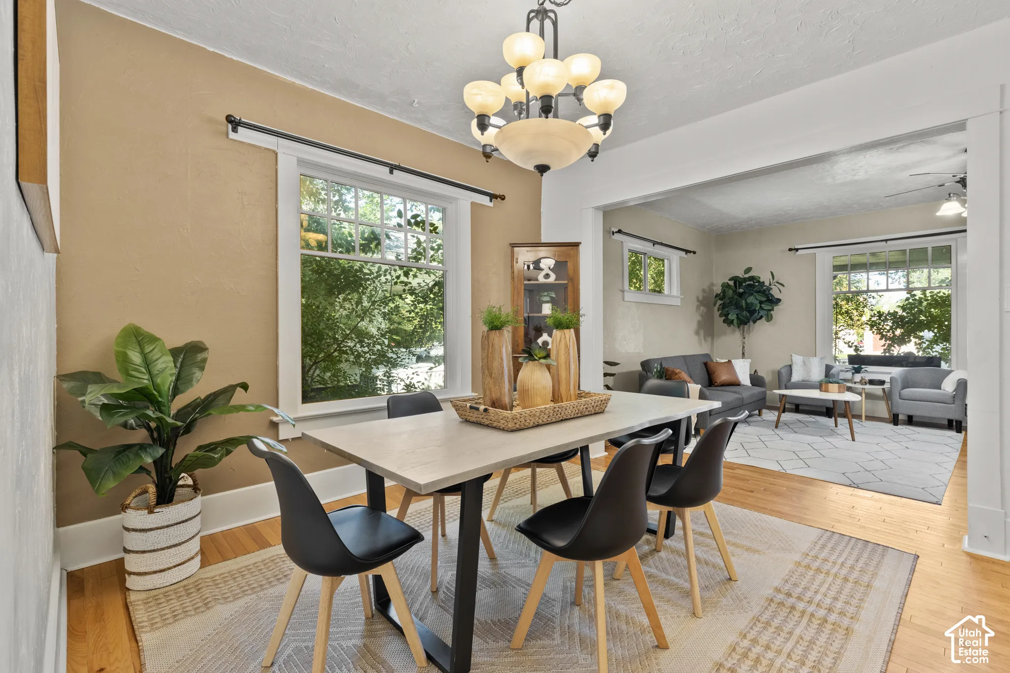 Open-concept dining/living room, oak wood floors & large windows