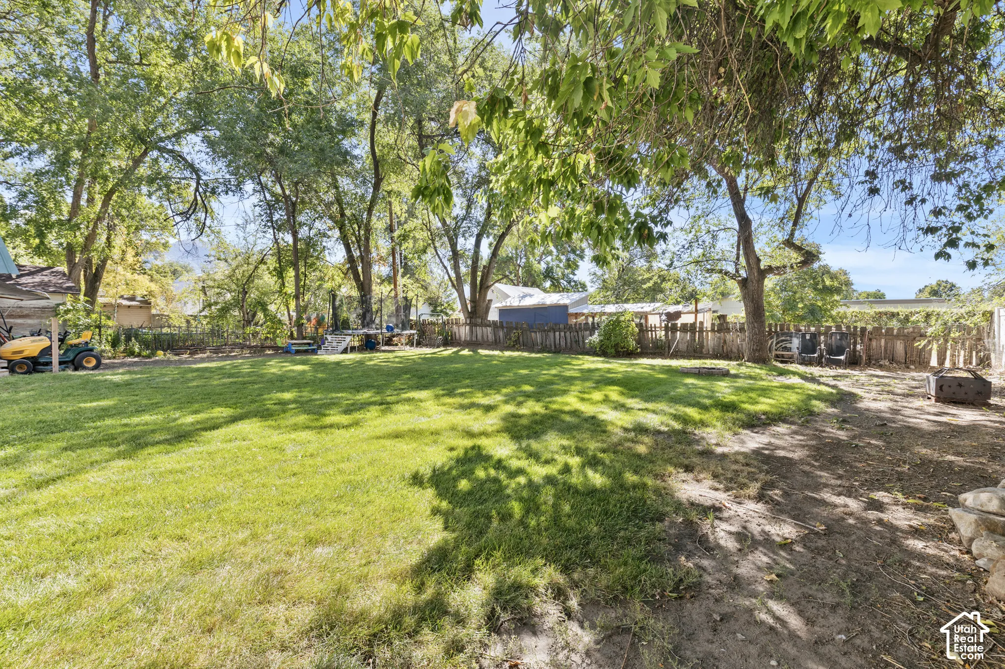 Expansive shaded back yard with mature trees, fully fenced.