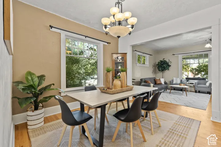 Open-concept dining/living room, oak wood floors & large windows