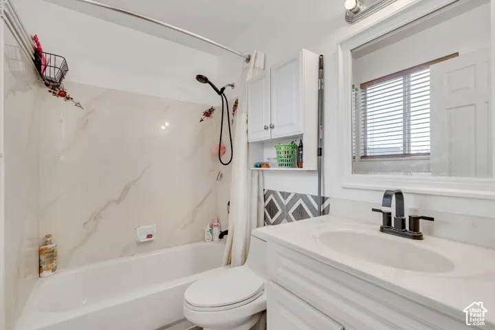 White single vanity with an integrated sink, matte black faucet, and framed mirror