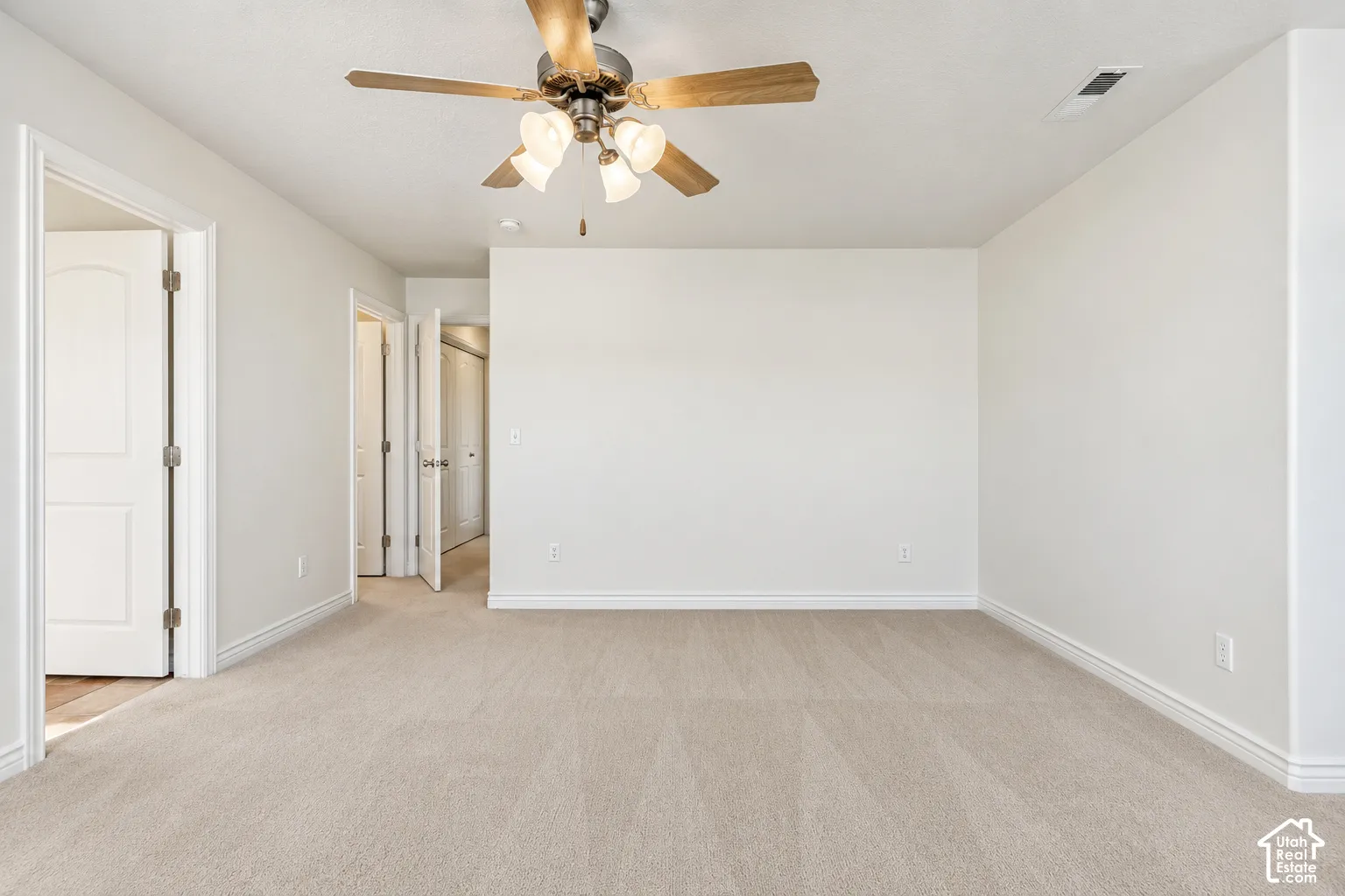 Primary Bedroom Neutral-toned wall paint with light-colored carpeting