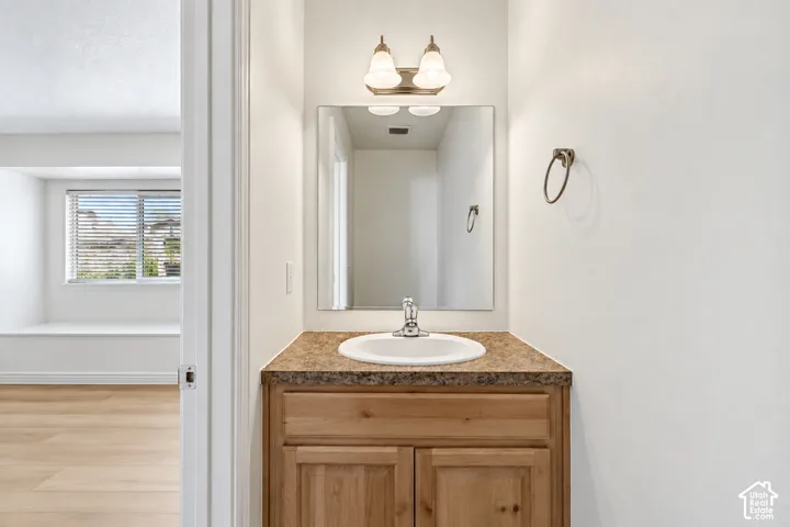 Wood-finish vanity with an integrated sink and laminate countertop