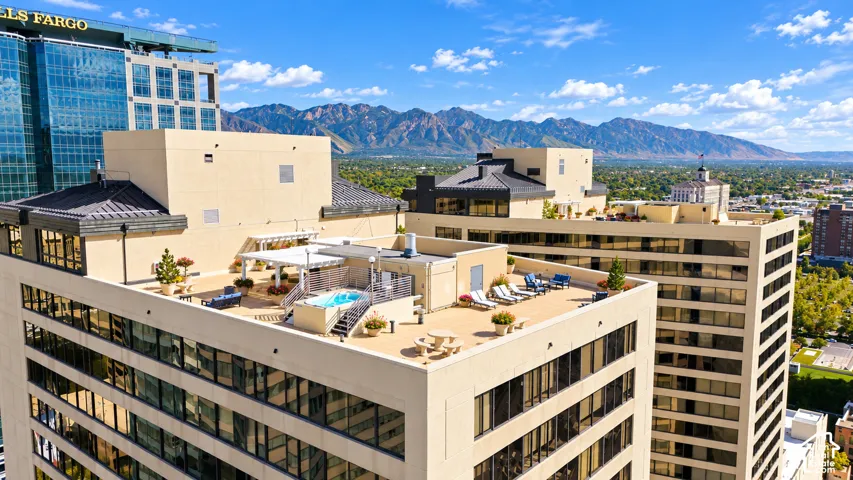 Rooftop terrace featuring a built-in spa, pergola, and elevated lounging areas