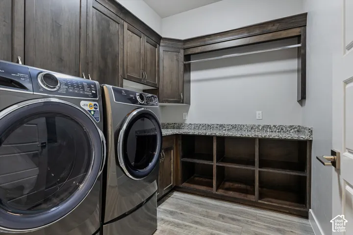 Dark wood-finish cabinetry, built-in shelving, granite-style countertop, and wood-finish flooring