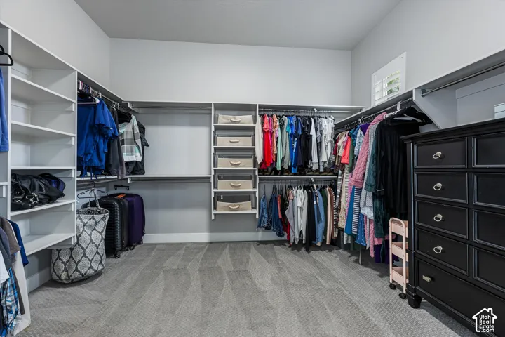 Custom closet system with multiple shelving units, hanging rods, and integrated storage bins