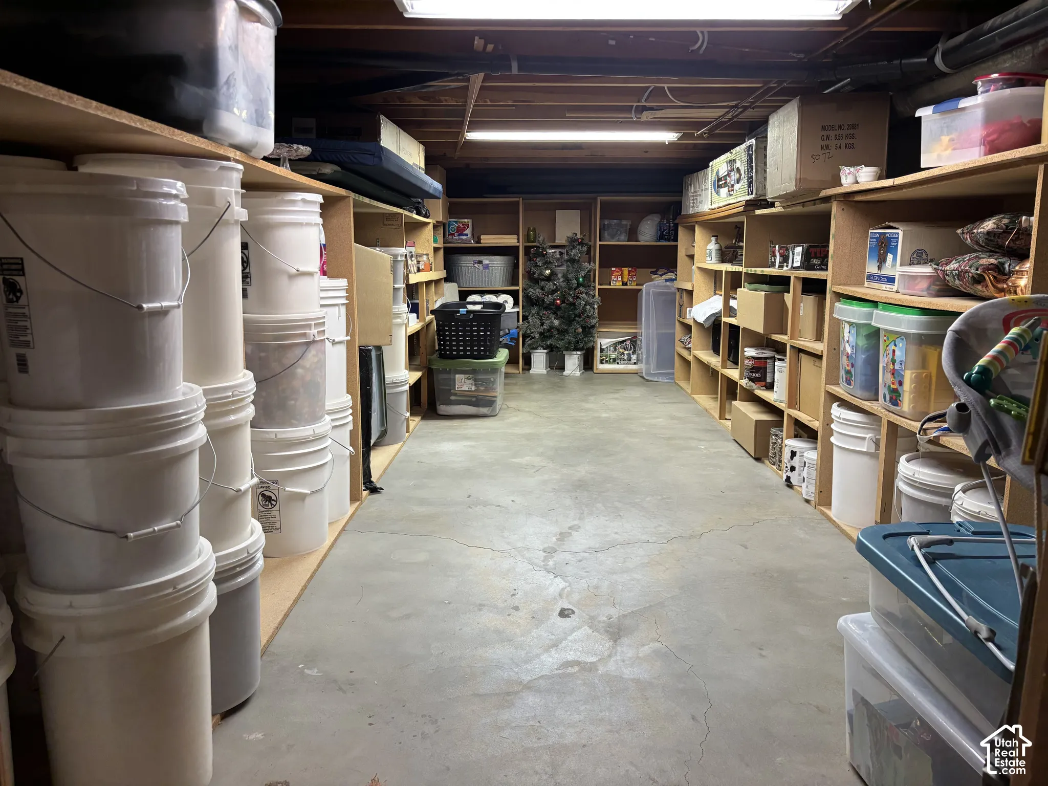 Concrete flooring with extensive built-in shelving, providing ample storage capacity