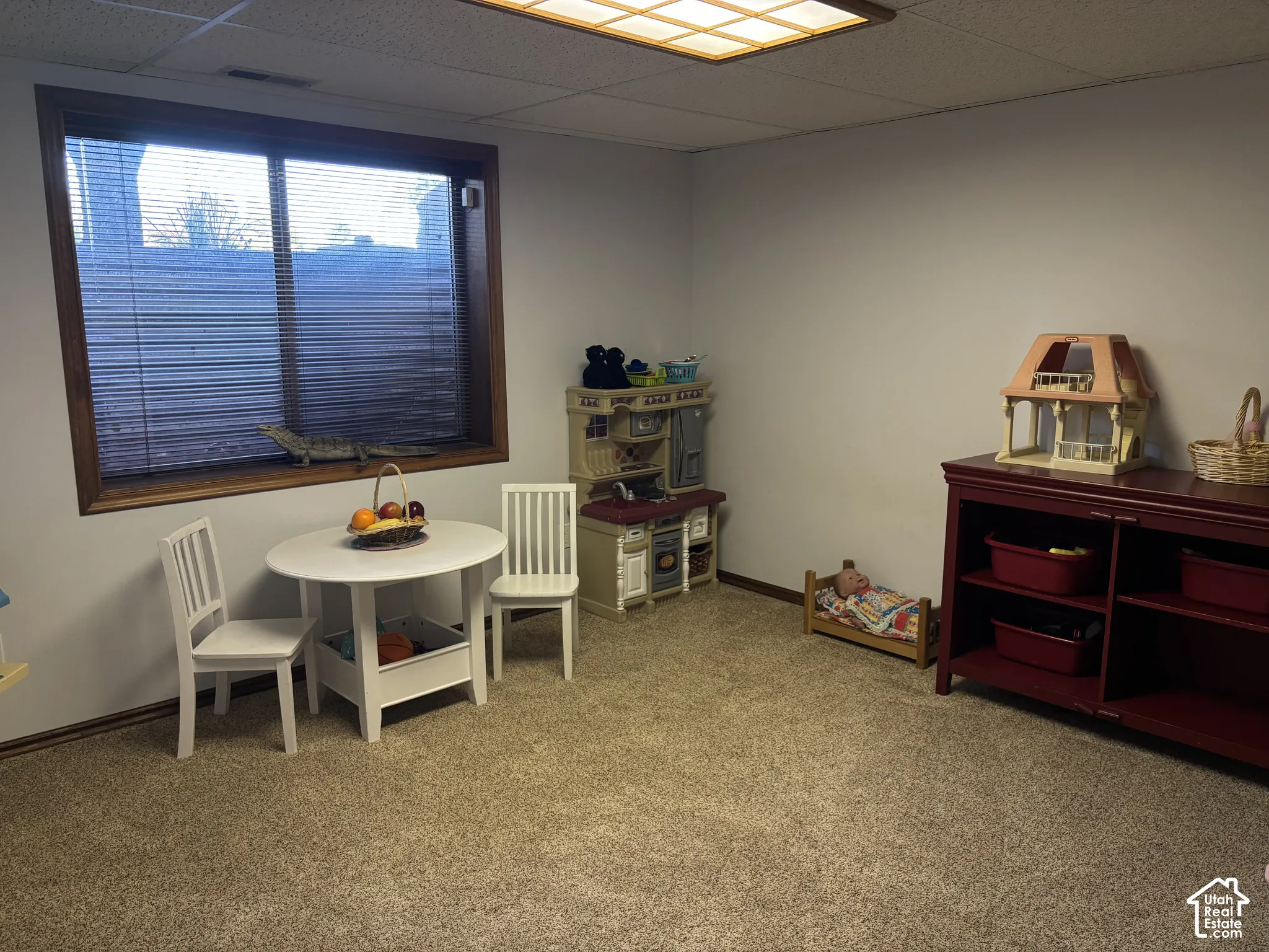 Wall-to-wall carpeting and a recessed window with wood trim