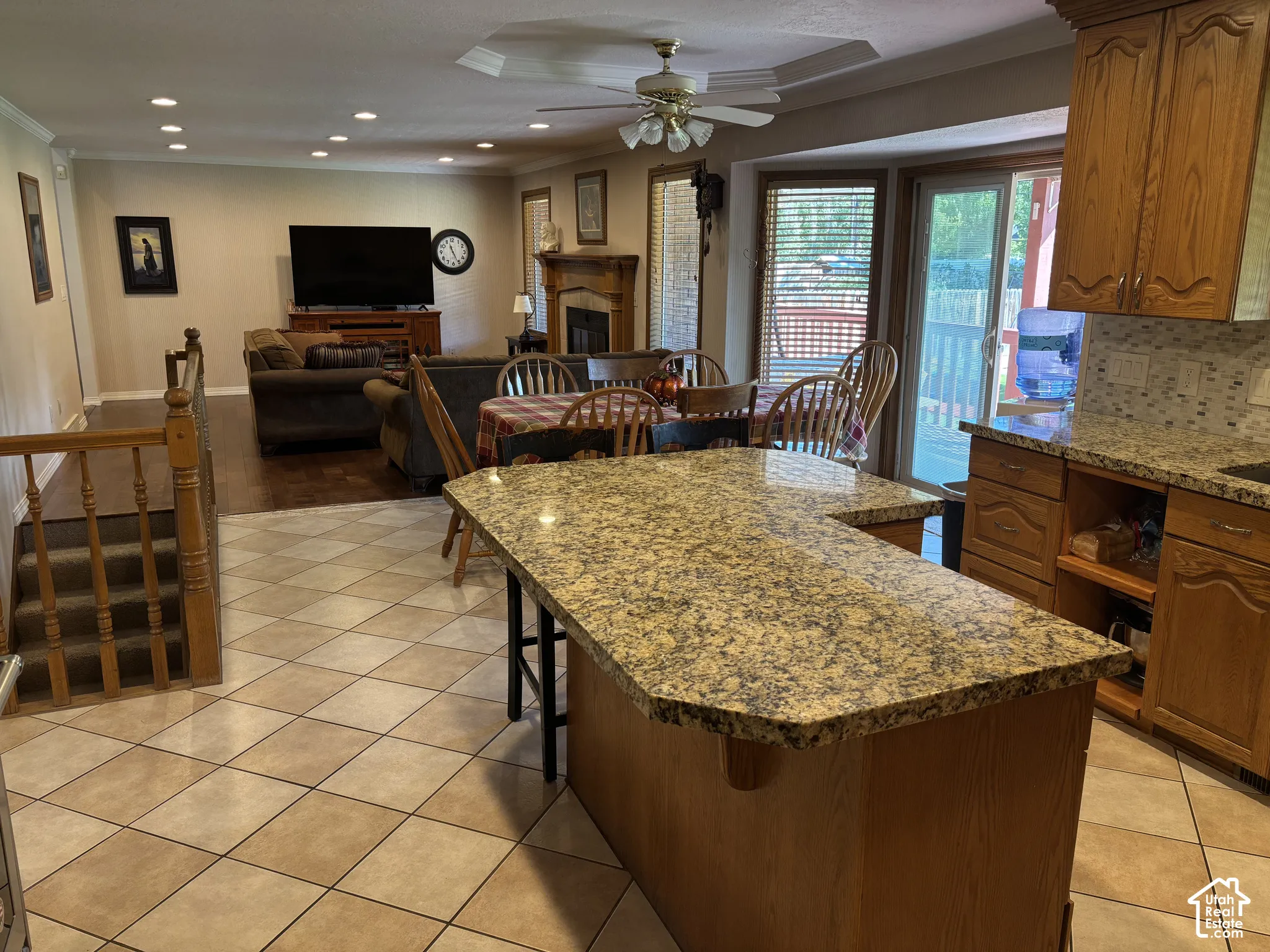 Kitchen featuring a granite-look island, tile flooring, and wood cabinetry