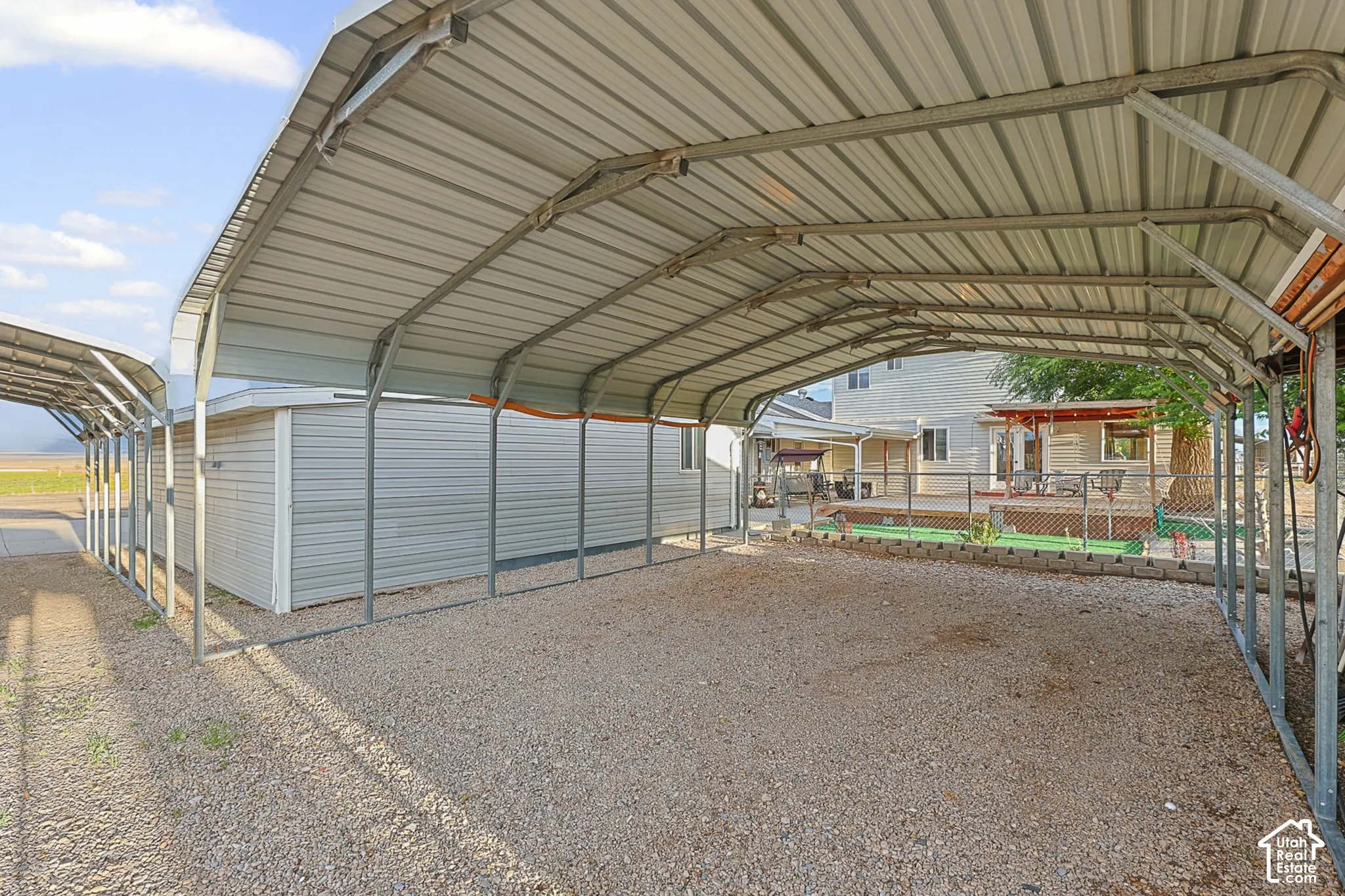Multiple covered carport spaces with gravel flooring