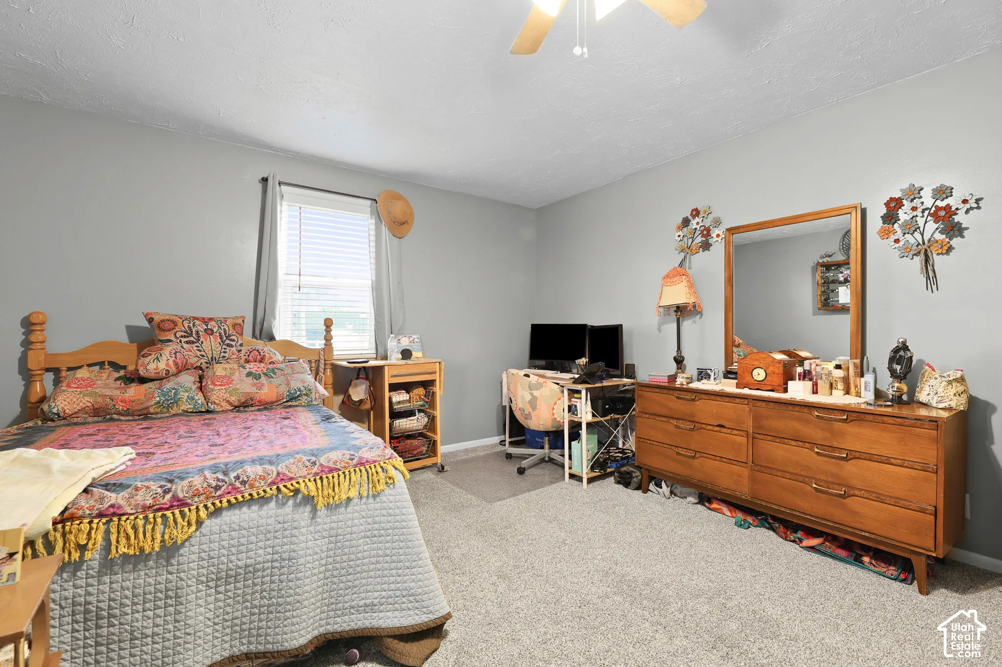 Carpeted flooring, window with blinds, ceiling fan with light fixture, light gray wall paint