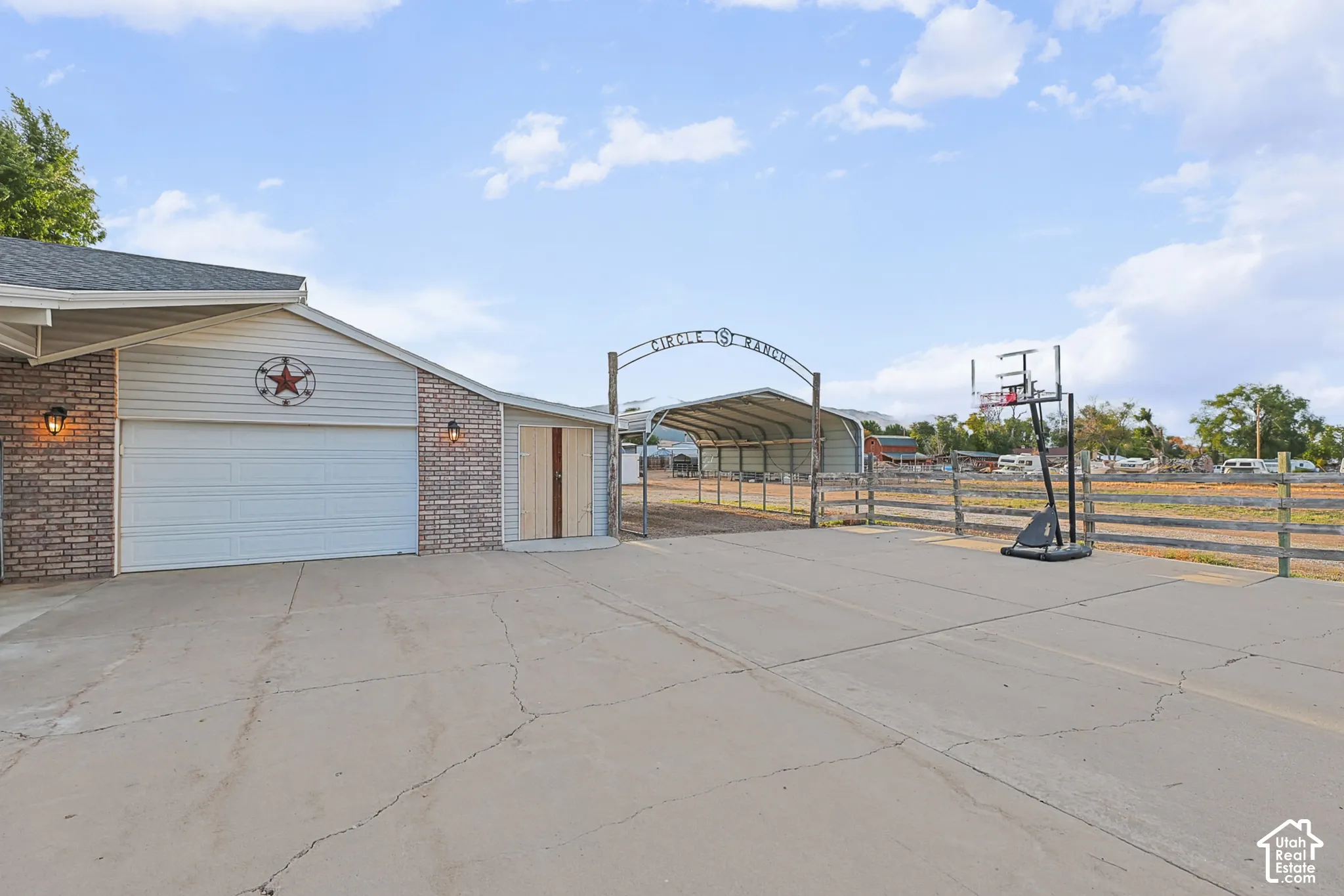 Attached garage with white door and exterior sconce lighting