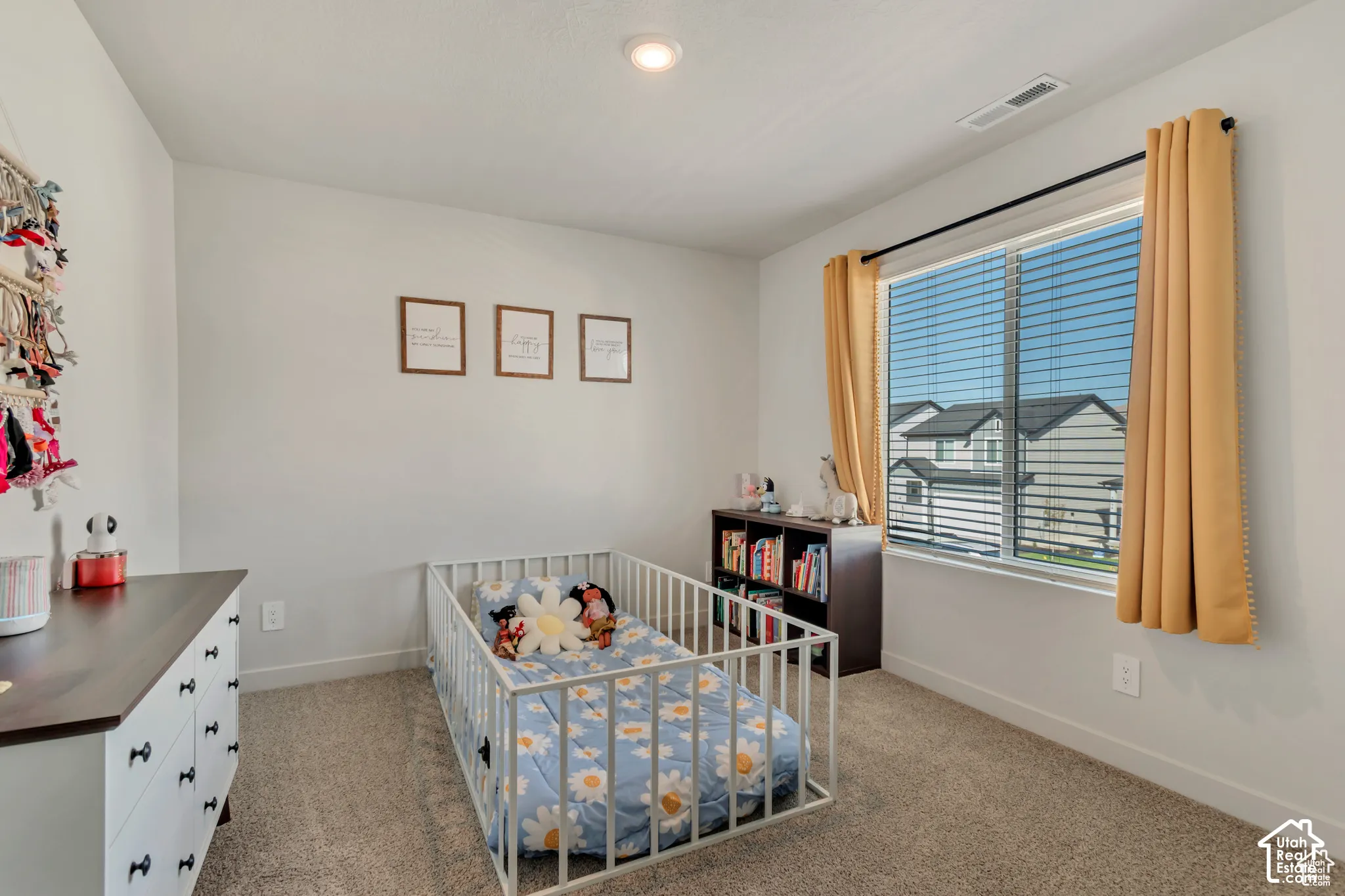 Carpeted flooring, recessed ceiling lighting, and a window with blinds