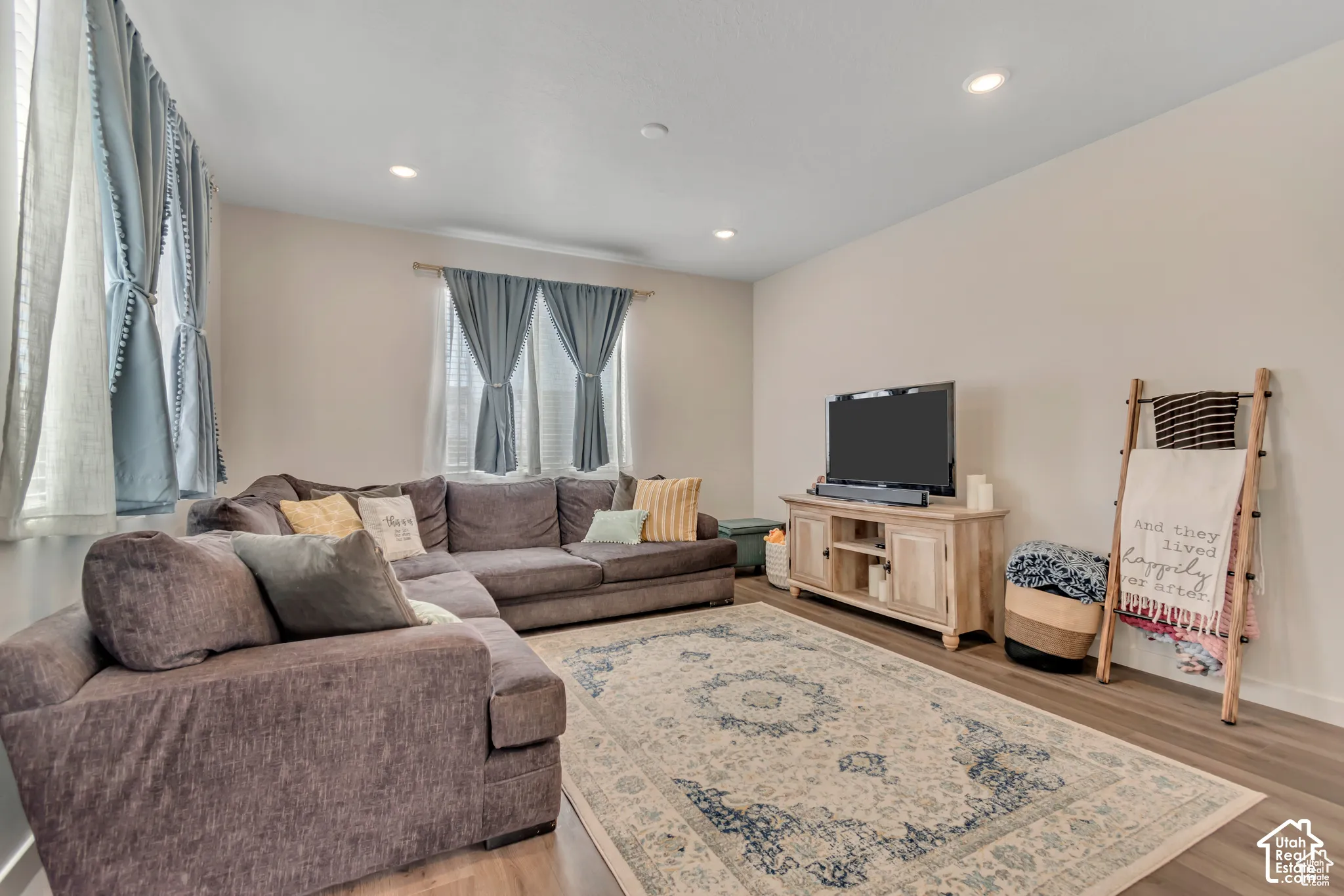 Recessed lighting, light wood-finish flooring, and light-toned walls