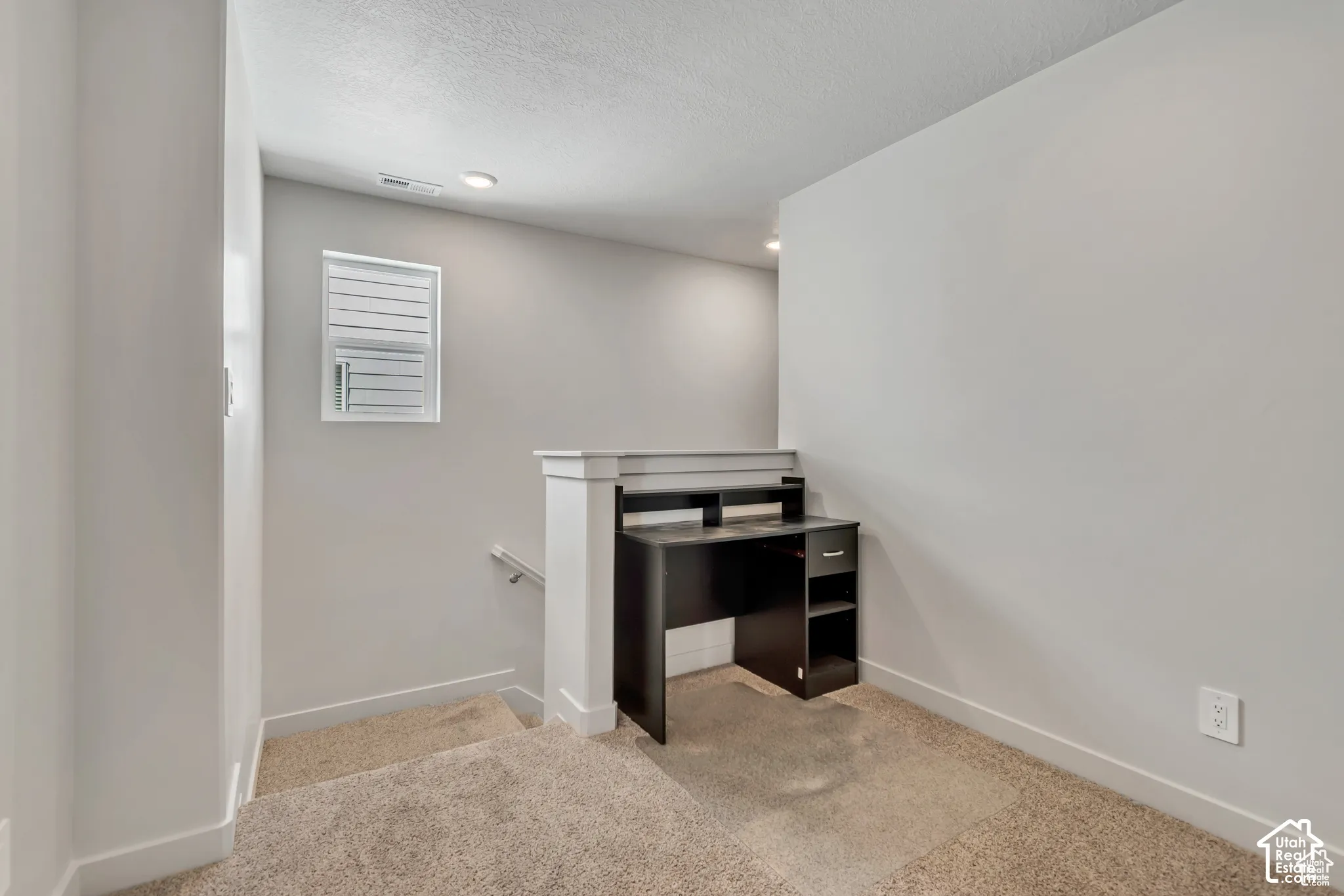 Carpeted staircase with white wall paneling