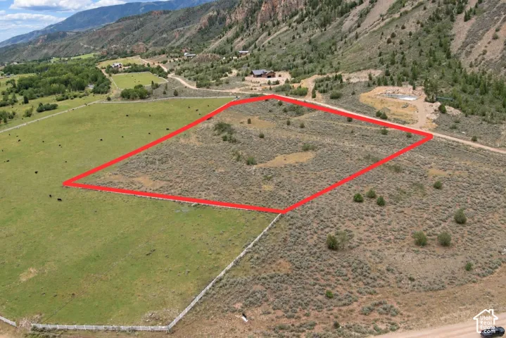 Expansive land parcel featuring natural terrain and a partial boundary outline