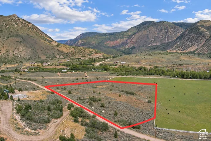 Expansive land parcel featuring natural terrain and distant mountain scenery